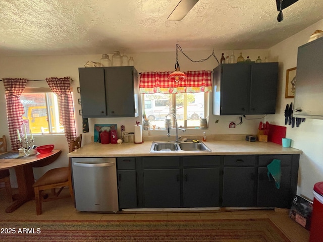 kitchen featuring sink, a textured ceiling, light tile patterned floors, and dishwasher