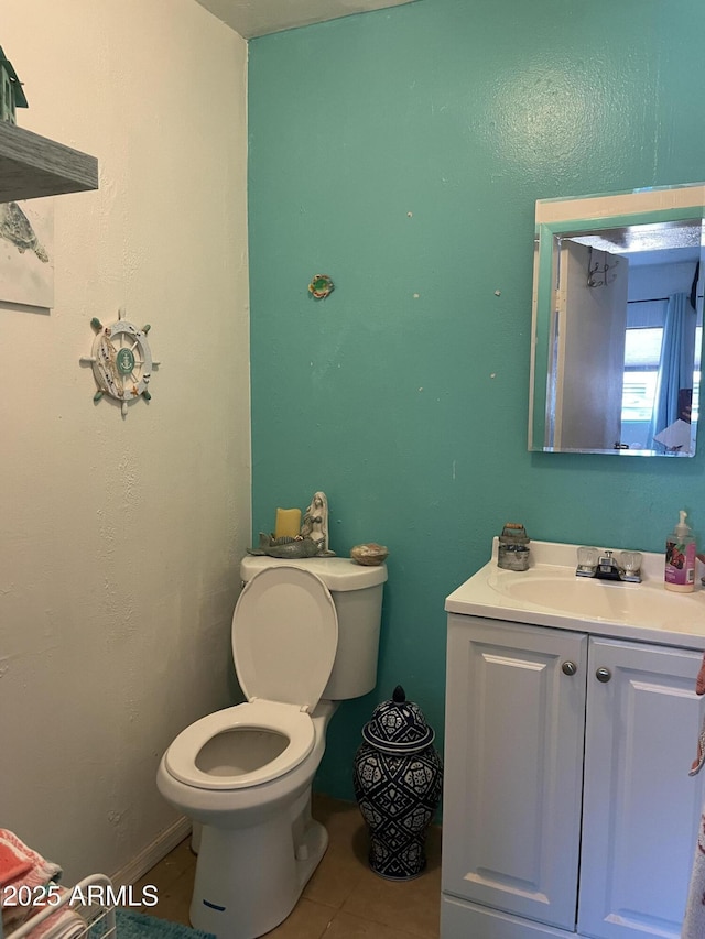 bathroom featuring tile patterned flooring, vanity, and toilet