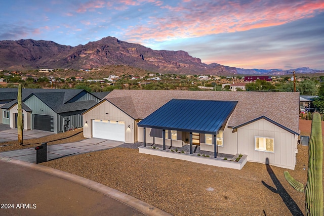 3939 S Veronica Ln, Gold Canyon, AZ 85118 - modern inspired farmhouse featuring cooling unit, concrete driveway, metal roof, a mountain view, and a garage