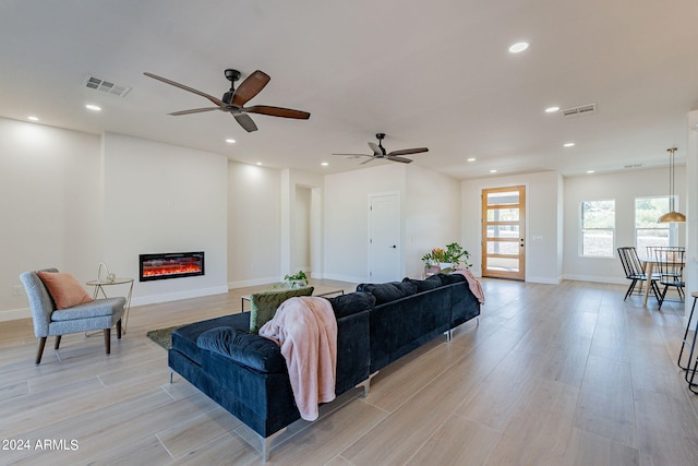 3939 S Veronica Ln, Gold Canyon, AZ 85118 - living room featuring light wood-type flooring, recessed lighting, visible vents, a ceiling fan, and a glass covered fireplace