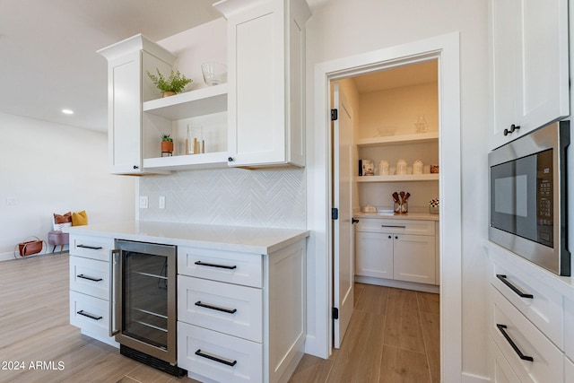 3939 S Veronica Ln, Gold Canyon, AZ 85118 - interior space featuring white cabinetry, light countertops, open shelves, stainless steel microwave, and beverage cooler
