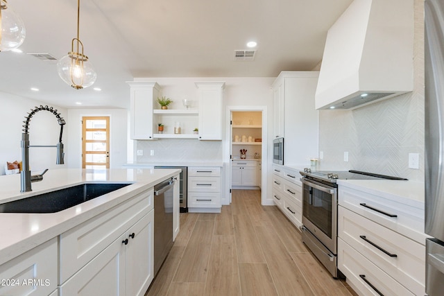 3939 S Veronica Ln, Gold Canyon, AZ 85118 - kitchen featuring visible vents, premium range hood, appliances with stainless steel finishes, a sink, and open shelves