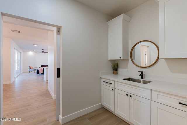 3939 S Veronica Ln, Gold Canyon, AZ 85118 - bar featuring baseboards, visible vents, light wood-type flooring, and a sink