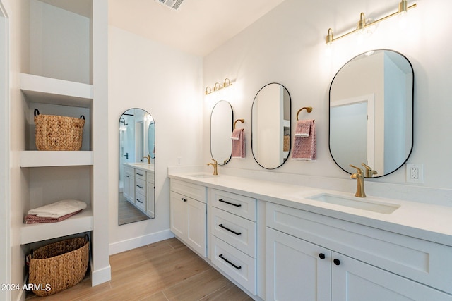 3939 S Veronica Ln, Gold Canyon, AZ 85118 - bathroom with double vanity, visible vents, wood finished floors, and a sink