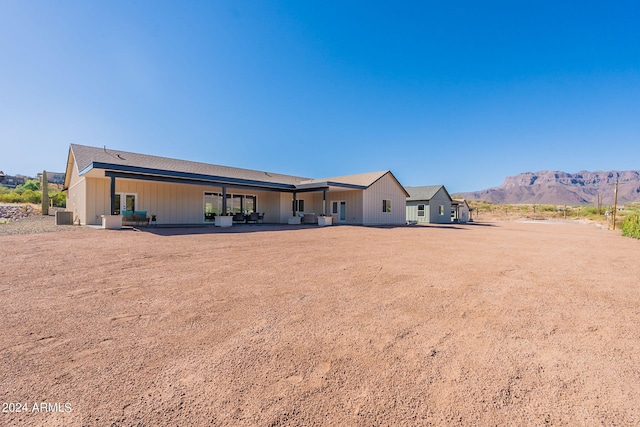 3939 S Veronica Ln, Gold Canyon, AZ 85118 - rear view of house with central air condition unit, a mountain view, and a patio area