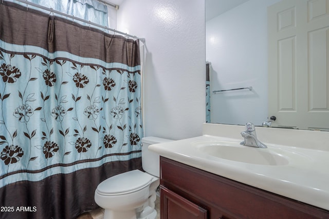 full bathroom with toilet, curtained shower, and vanity