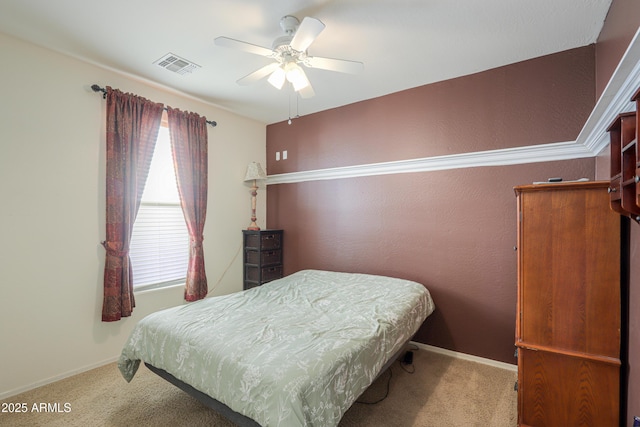 bedroom featuring light carpet, baseboards, visible vents, and a ceiling fan