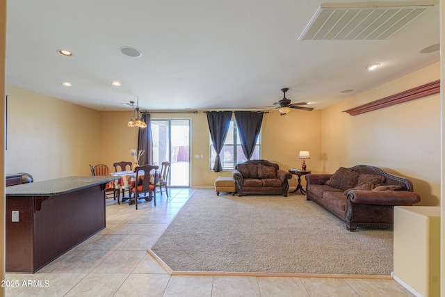 living area with ceiling fan, light tile patterned floors, recessed lighting, light colored carpet, and visible vents