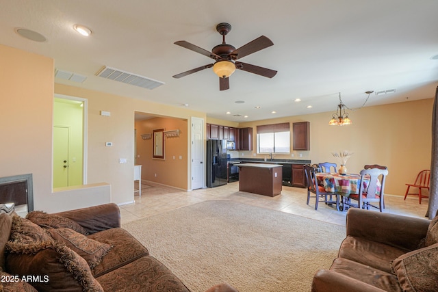 living room featuring light carpet, light tile patterned floors, recessed lighting, visible vents, and ceiling fan with notable chandelier