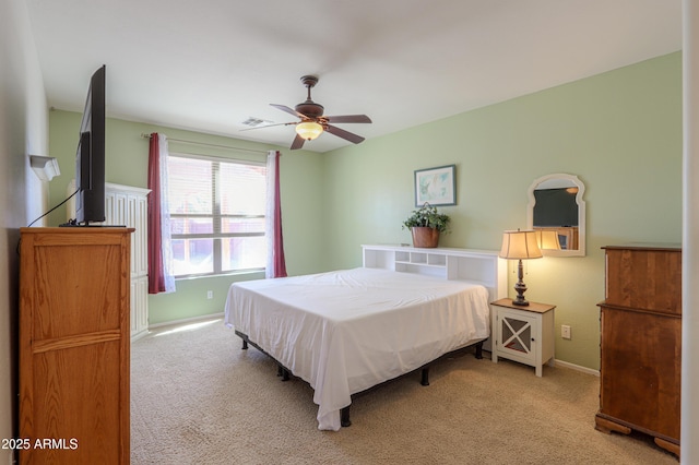 bedroom featuring light colored carpet, ceiling fan, visible vents, and baseboards