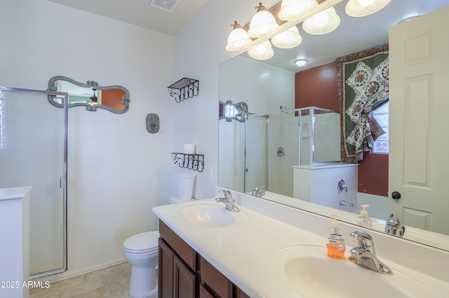 full bathroom with double vanity, a stall shower, a sink, and toilet