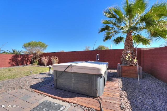 view of yard with a fenced backyard and a hot tub