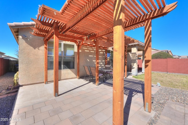 view of patio / terrace with outdoor dining space, a fenced backyard, and a pergola