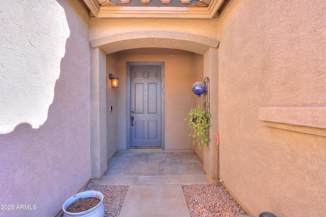 doorway to property with stucco siding