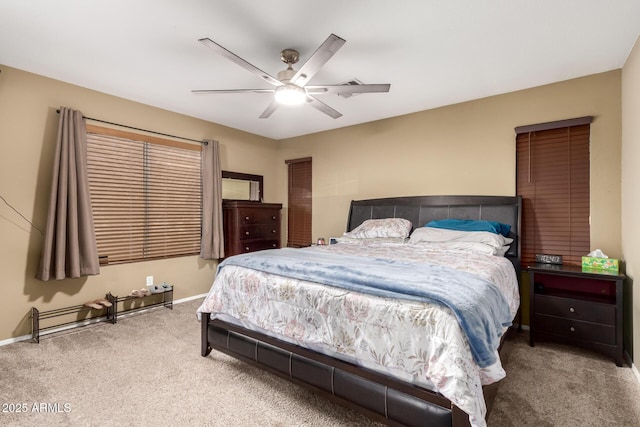 carpeted bedroom featuring ceiling fan and baseboards