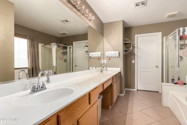 bathroom with visible vents, a shower stall, and a sink
