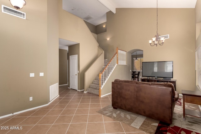 living area featuring visible vents, stairway, high vaulted ceiling, beamed ceiling, and a chandelier