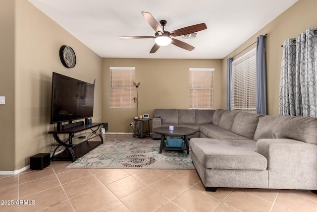living room with baseboards, a ceiling fan, and light tile patterned flooring