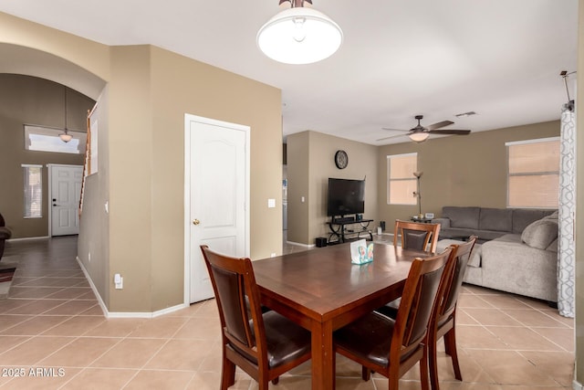 dining area with ceiling fan, light tile patterned flooring, and a healthy amount of sunlight