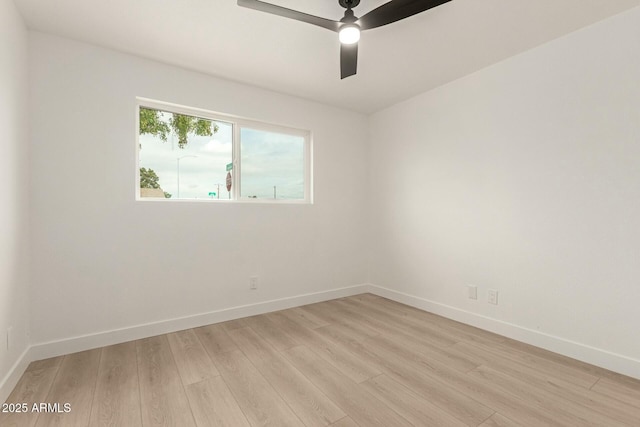 spare room with ceiling fan and light wood-type flooring