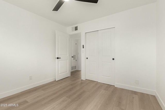 unfurnished bedroom featuring ceiling fan, a closet, and light hardwood / wood-style flooring