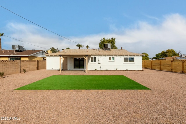 rear view of house with a yard, central AC, and a patio area