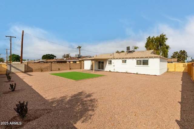 rear view of property with cooling unit