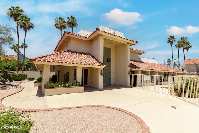 7115 E Buena Terra Way, Paradise Valley, AZ 85253 - mediterranean / spanish-style house featuring stucco siding, a tiled roof, and a patio