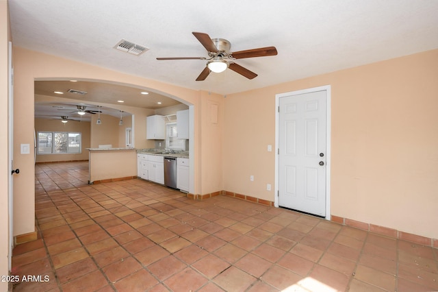 kitchen featuring sink, ceiling fan, white cabinets, stainless steel dishwasher, and kitchen peninsula