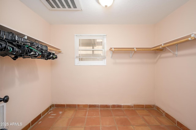 walk in closet with tile patterned flooring