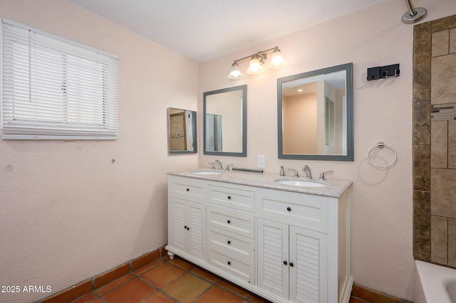 bathroom featuring tiled shower / bath combo, vanity, and tile patterned floors