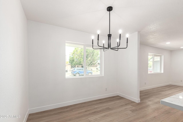 524 S Pioneer, Mesa, AZ 85204 - unfurnished dining area featuring a chandelier, plenty of natural light, light wood finished floors, and baseboards