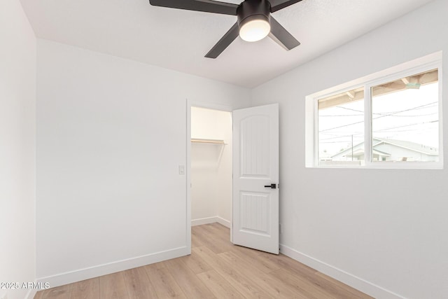 524 S Pioneer, Mesa, AZ 85204 - unfurnished bedroom with a spacious closet, baseboards, light wood-style floors, a closet, and a ceiling fan