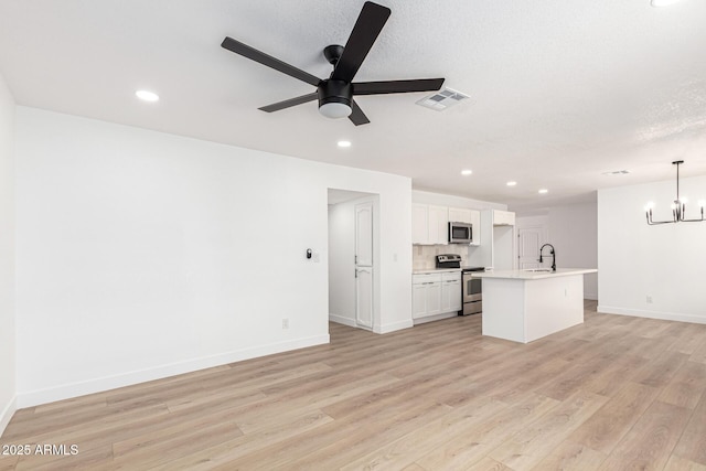 524 S Pioneer, Mesa, AZ 85204 - kitchen with stainless steel appliances, a sink, ceiling fan, light wood finished floors, and light countertops