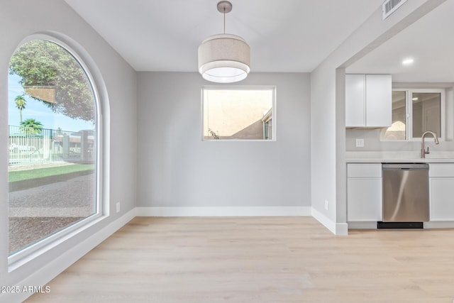 unfurnished dining area featuring light hardwood / wood-style flooring