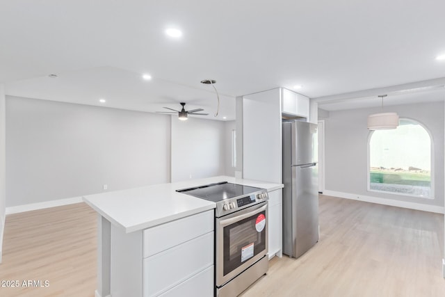 kitchen featuring decorative light fixtures, ceiling fan, stainless steel appliances, light hardwood / wood-style floors, and white cabinets