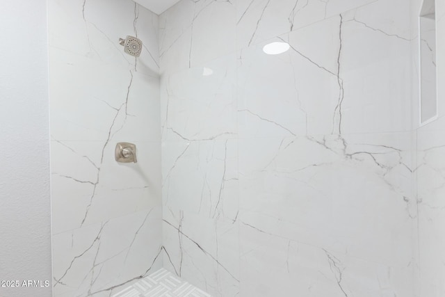 bathroom with a tile shower