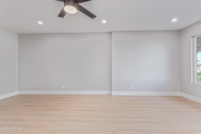 spare room with ceiling fan and light wood-type flooring