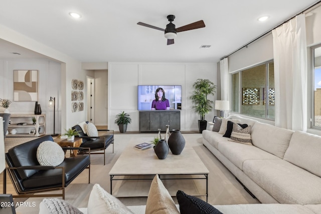 living room with a ceiling fan, recessed lighting, and visible vents