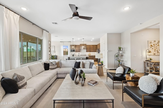 living room featuring ceiling fan, visible vents, and recessed lighting