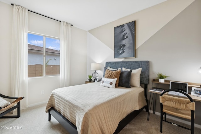 bedroom featuring carpet and baseboards