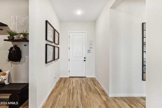 corridor with light hardwood / wood-style floors