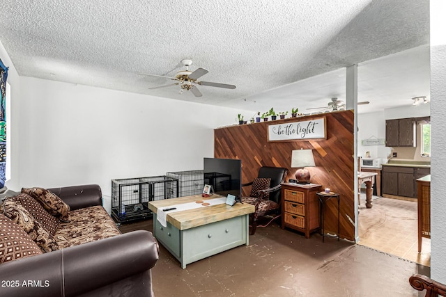 4438 W Hatcher Rd, Glendale, AZ 85302 - living area with ceiling fan, finished concrete flooring, and a textured ceiling