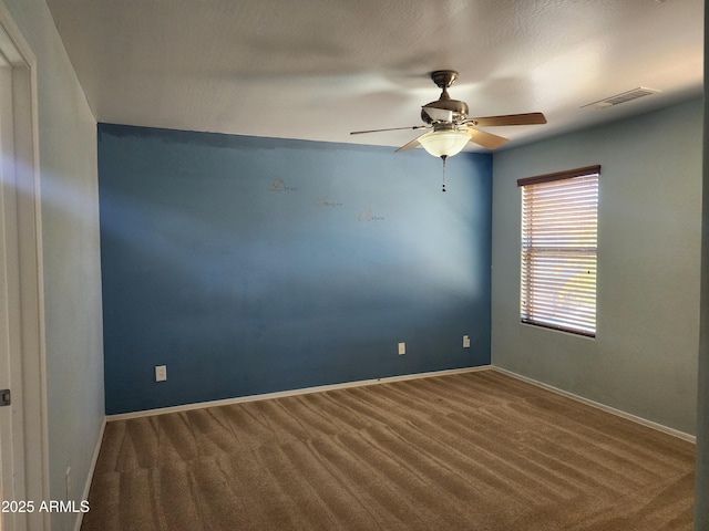 empty room featuring carpet and ceiling fan