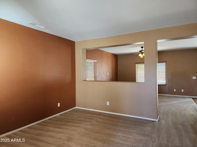 empty room with ceiling fan and carpet