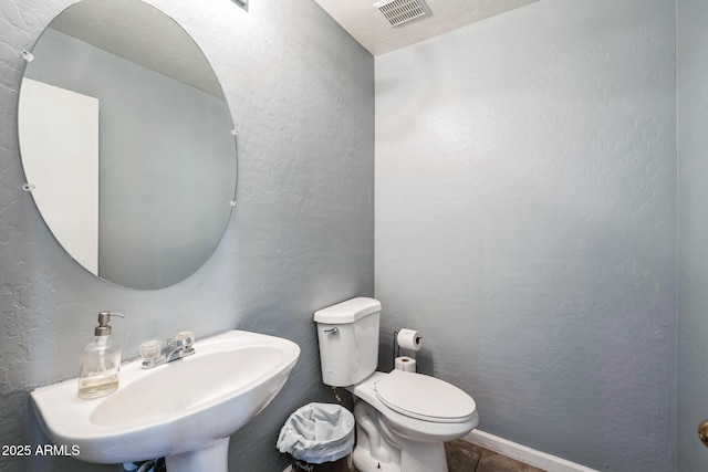 bathroom featuring sink and toilet