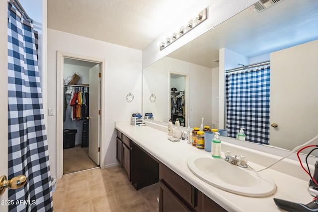 bathroom featuring tile patterned flooring and vanity