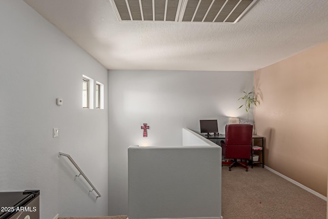 home office with carpet flooring, visible vents, baseboards, and a textured ceiling