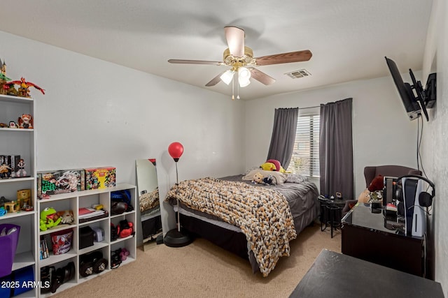 carpeted bedroom with a ceiling fan and visible vents
