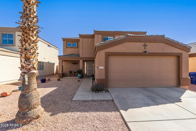 view of front facade with a tile roof, driveway, a garage, and stucco siding